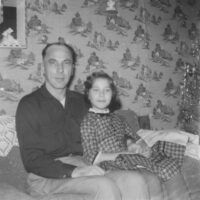 Cheri Teal as a child, sitting with her father.