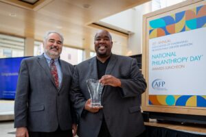 Tom Linfield and Michael Johnson pose with Michael's 2022 Outstanding Fundraising Professional award