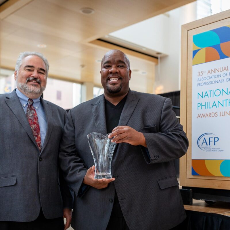 Tom Linfield and Michael Johnson pose with Michael's 2022 Outstanding Fundraising Professional award