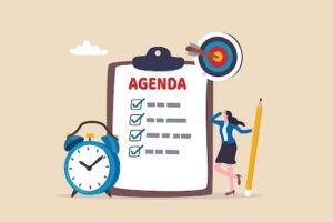 An illustration of an alarm clock, a clipboard with a checklist and the headline "Agenda" and a person holding a pencil leaning against the clipboard.