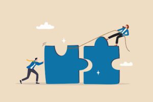 An illustration of two large puzzle pieces with a person on top of the one piece pulling with a rope and a person on the ground pushing to bring them together.