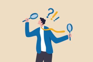 Illustration of a person holding magnifying glasses in both hands with a question mark and two exclamation points over their head.