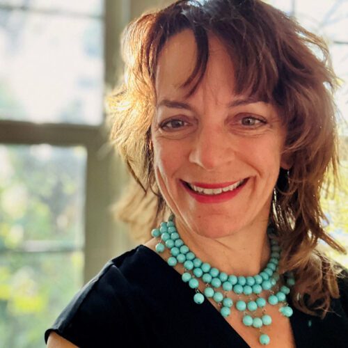 Headshot photo of Jeneen Hartley wearing a black top with a turquoise necklace.