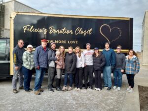 Felicia's Donation Closet volunteers pose in front of their 15-foot moving truck after another successful move in day.