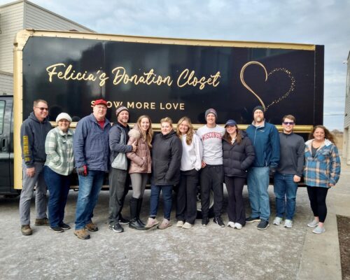 Felicia's Donation Closet volunteers pose in front of their 15-foot moving truck after another successful move in day.