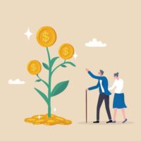 Elderly man and woman looking at a tree with big coins on it, indicating growth of an investment