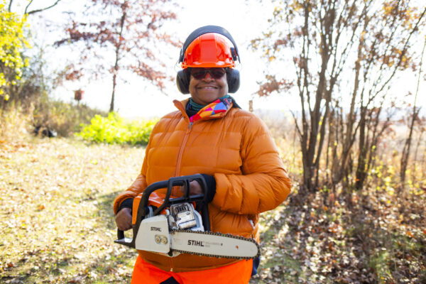 Woman holding chainsaw