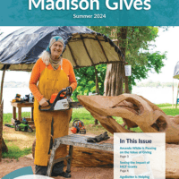 Cover of Madison Gives Summer 2024 print newsletter showing a woman sculptor working on a large wooden sculpture with a chainsaw.
