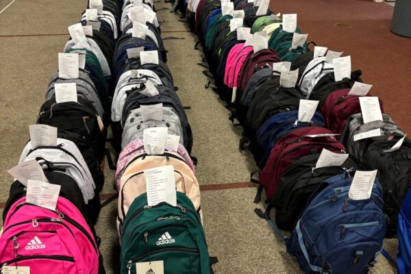 Hundreds of backpacks packed with supplies and ready to be given away to students