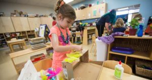 young girl doing arts and crafts at her daycare