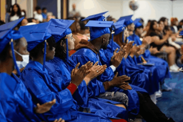 Group of graduates clapping at ceremony