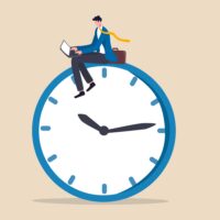 Man sitting on top of a clock