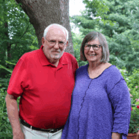 Couple poses for portrait in their garden