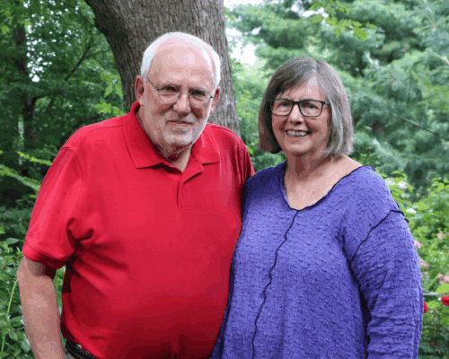 Couple poses for portrait in their garden