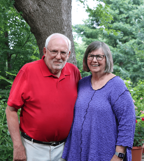 Couple poses for portrait in their garden