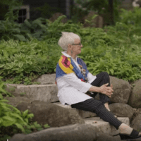 Barbara Johnson sits on steps outside her home