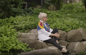 Barbara Johnson sits on steps outside her home