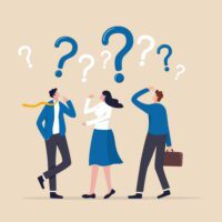 Three people in business clothes with question marks over their heads